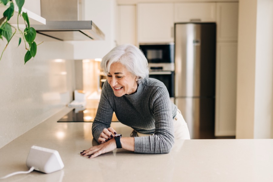 An older woman smiling comfortably at home